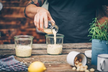 Der Vanilledrink wird auf 2 Gefäße aufgeteilt, in denen sich Oats befinden