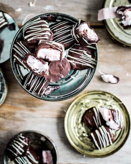 Joghurt-Erdbeereis mit Schokoüberzug auf verschiedenen Tellerchen.seviert.