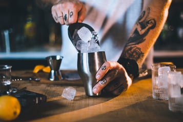 Eis in einen Cocktailshaker füllen für den Aperol Sour.
