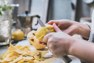 Quitten in der Hand mit einem Messer schälen