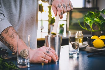 Rucola für die Rucola-Limonade wird mit dem Muddler im Shaker zerstoßen.