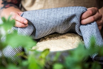 Berliner-Teig mit einem Geschirrtuch abgedeckt gehen lassen