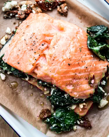 Gefüllter Lachs mit Feta und Spinate in einer Auflaufform auf Backpapier
