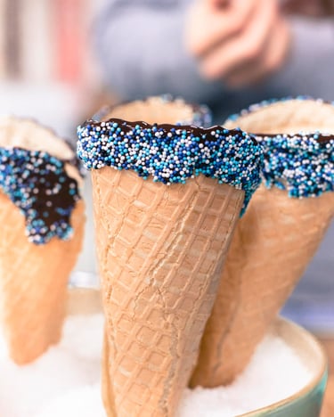 Eiswaffeln in Schokolade getaucht und mit Streuseln verziert